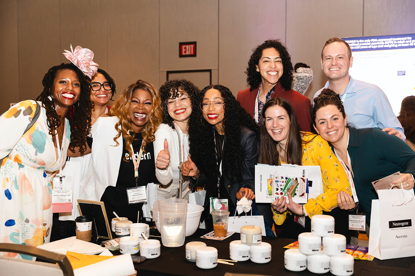 Attendees gathered at an exhibit table